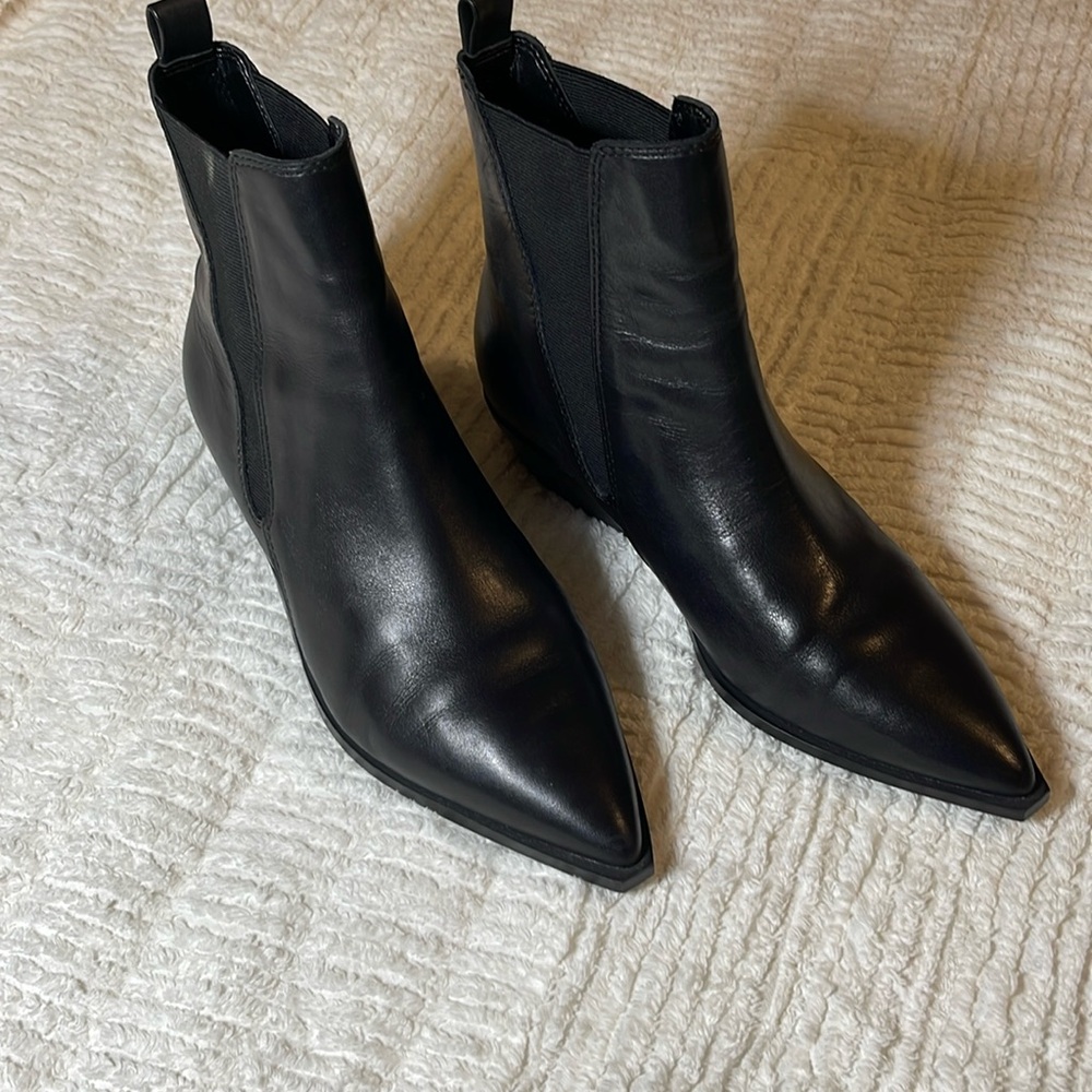 Black pointed boots with 1 1/4 inch heels.